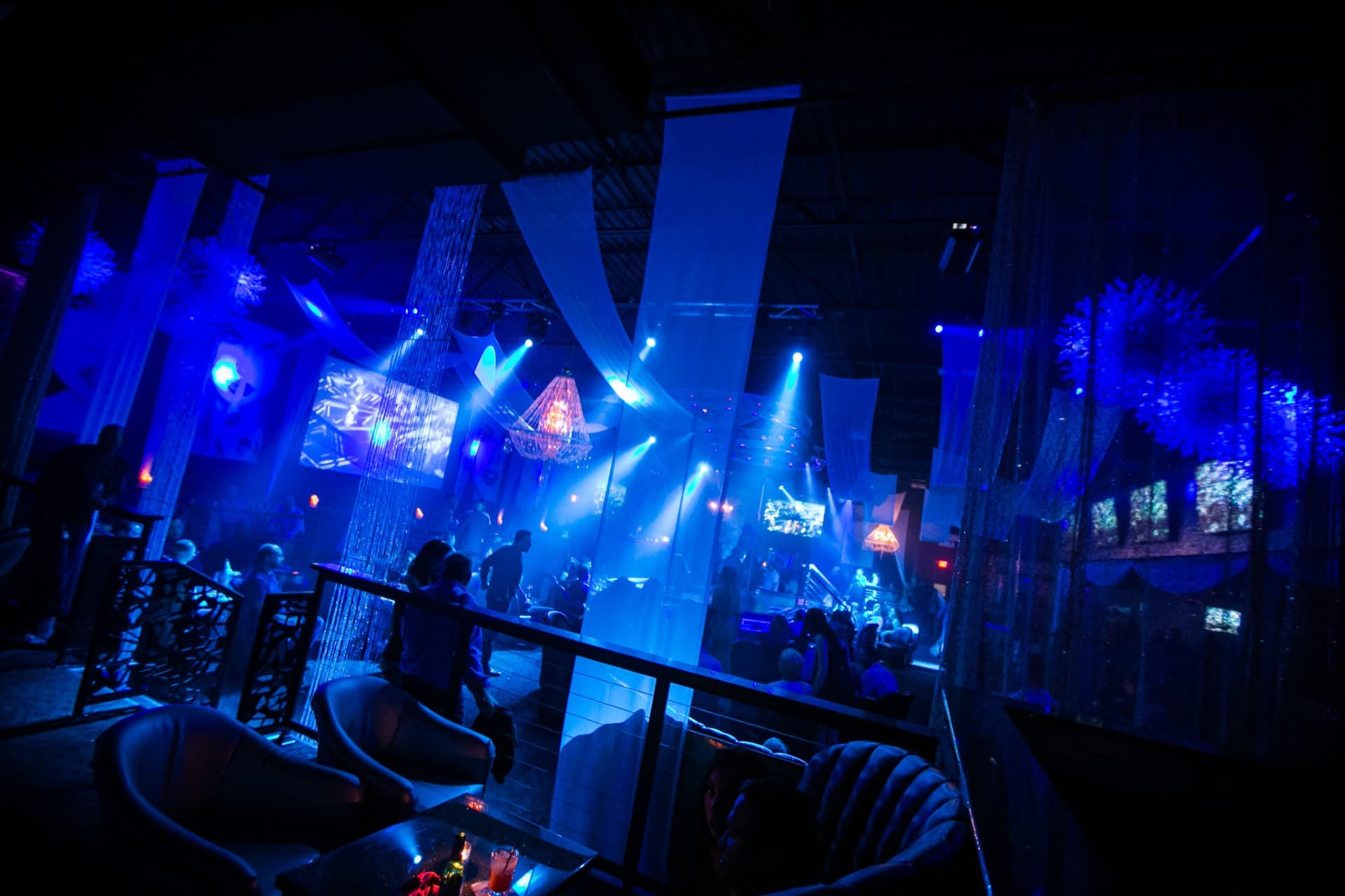 Blue-lit VIP lounge seating and chandeliers at The Gold Room Chicago