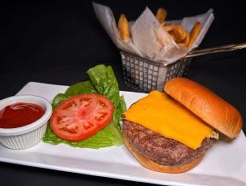 Delicious cheeseburger served with fresh vegetables and crispy fries at The Gold Room Chicago.