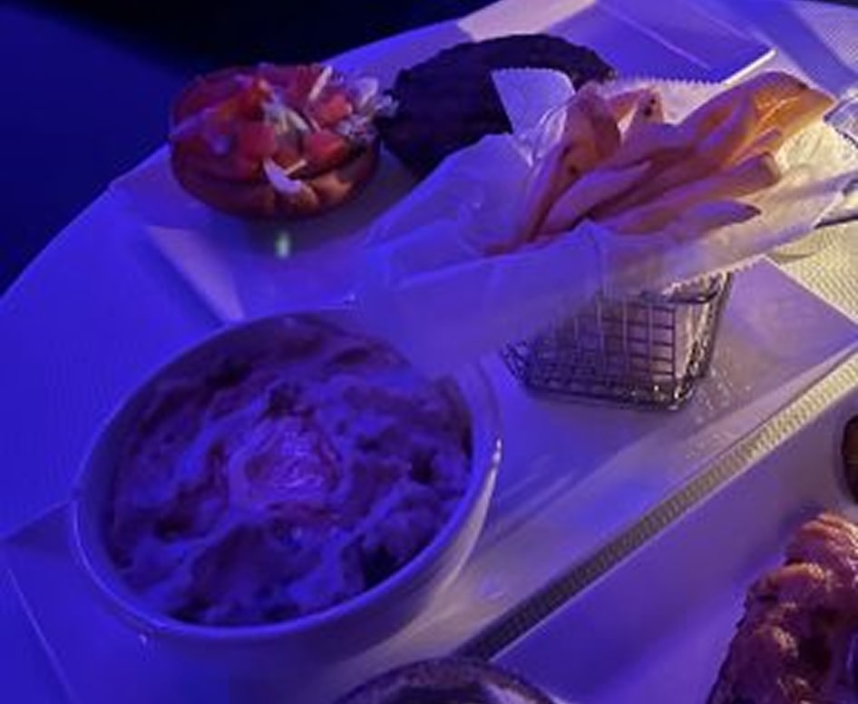 Elegant menu offerings including fresh fruit, crispy fries, and savory dishes in a luxurious setting.