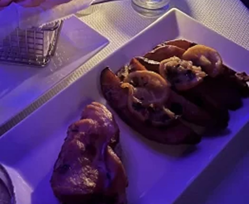 Delicious chicken wings and shrimp served on a white platter at The Gold Room Chicago.