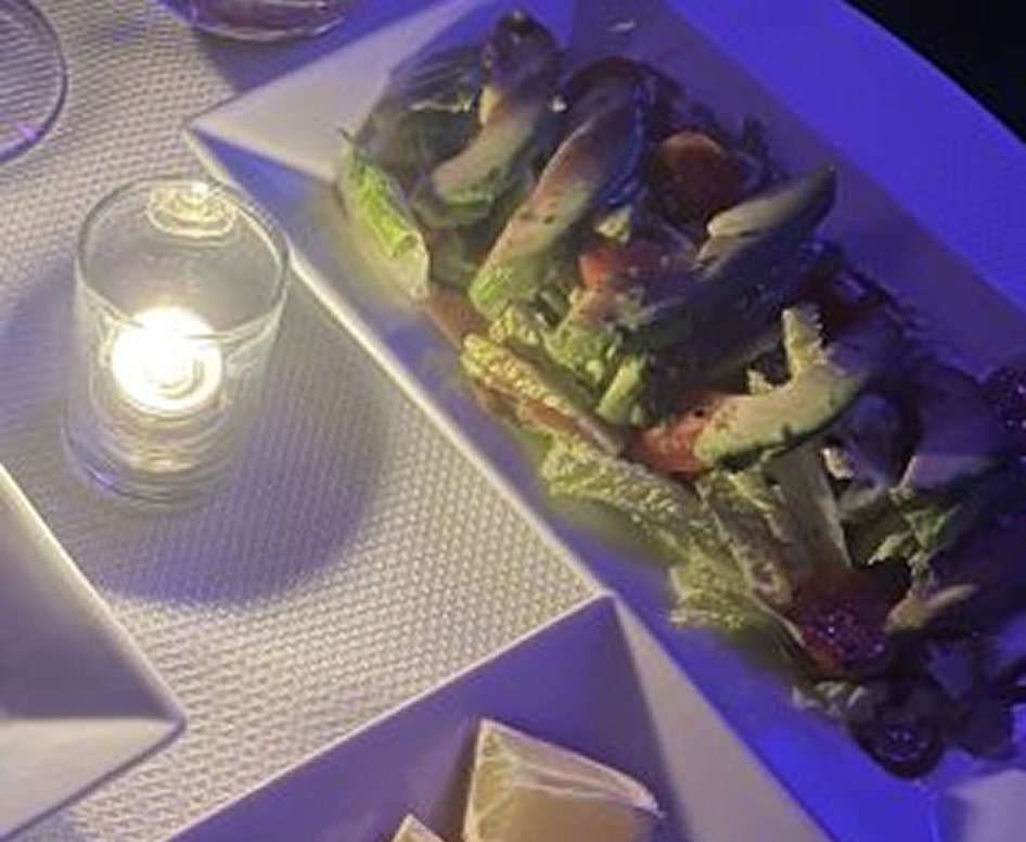 Fresh mixed salad with vegetables served on a white platter at The Gold Room Chicago.