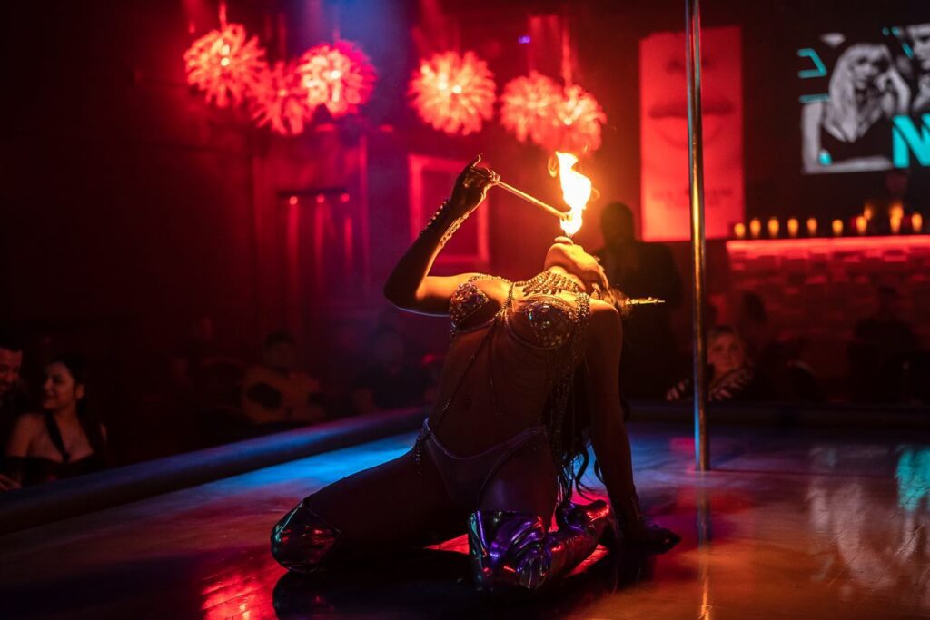 Performer performing fire dance at The Gold Room Chicago strip club.